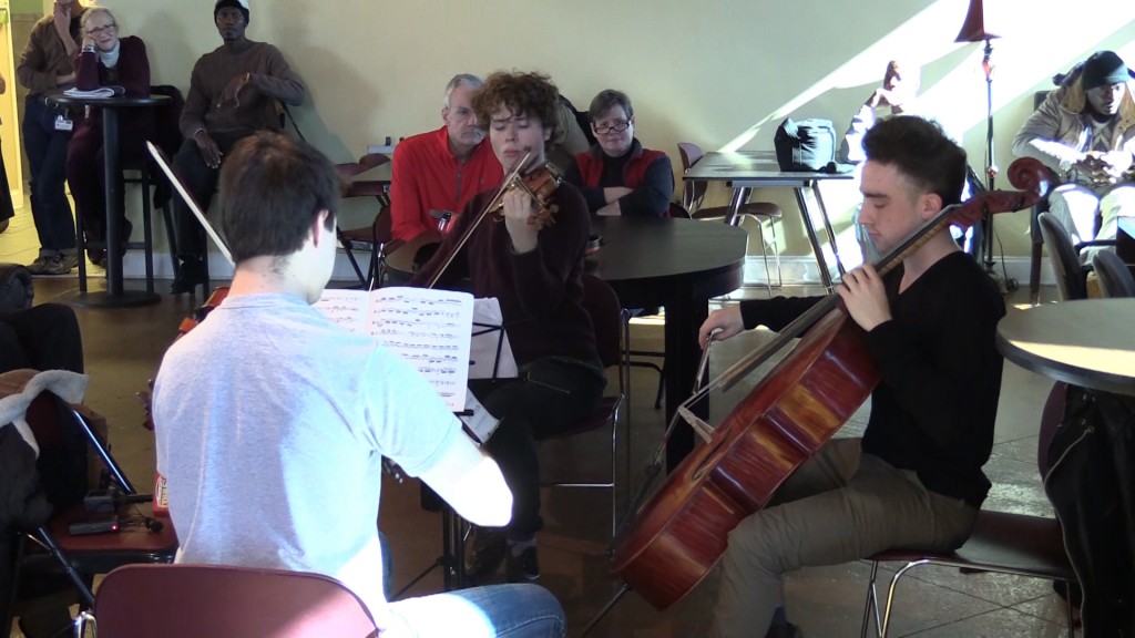 Mercer String Trio plays for homeless at Daybreak.