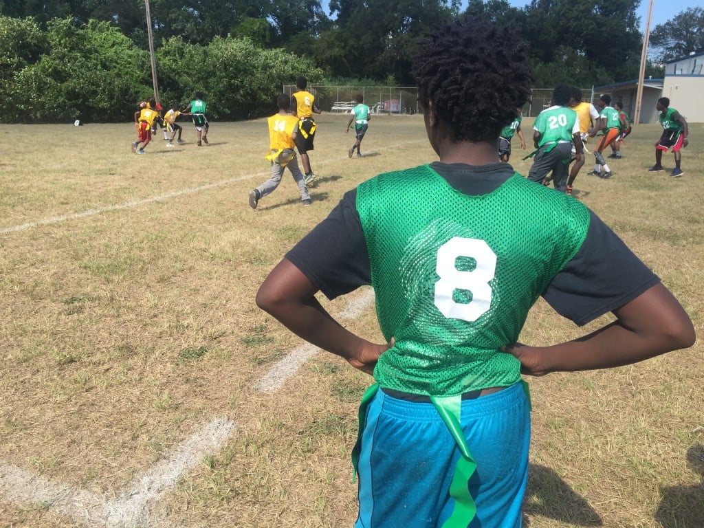 A student looks on at the flag football game hosted by the Bibb County Sheriff's Outreach Office Tuesday.