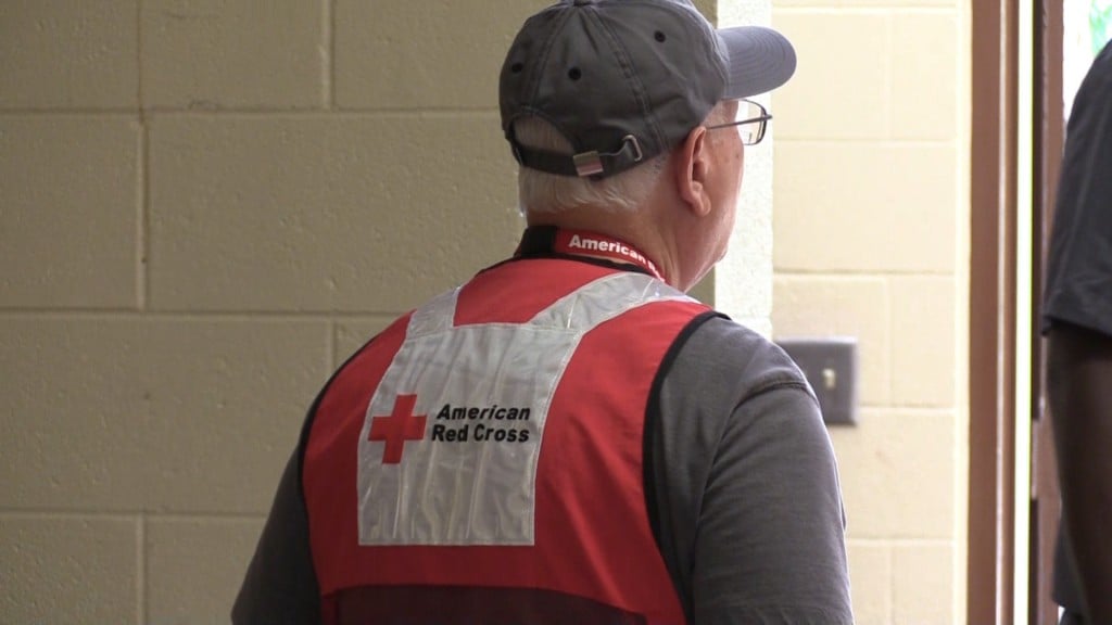 Red Cross volunteer Charlie Norman looks on as families arrive.