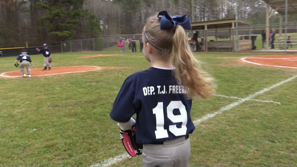 A member of the Crawford County Recreation Department Wee Ball Yankees wears fallen Bibb County Sheriff's Office Investigator T.J. Freeman's name across her back.