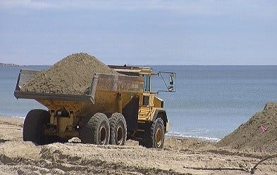 Trucks of sand arrive at Misquamicut