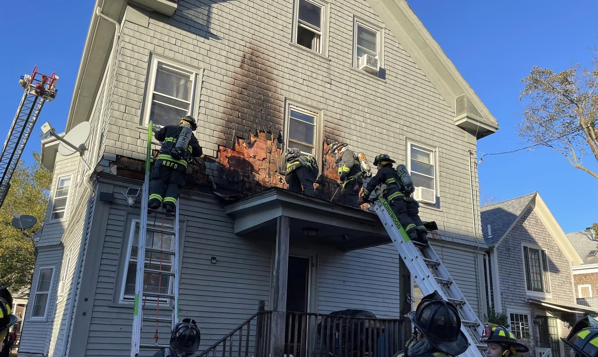 Firefighters rescue elderly woman, dog from New Bedford fire