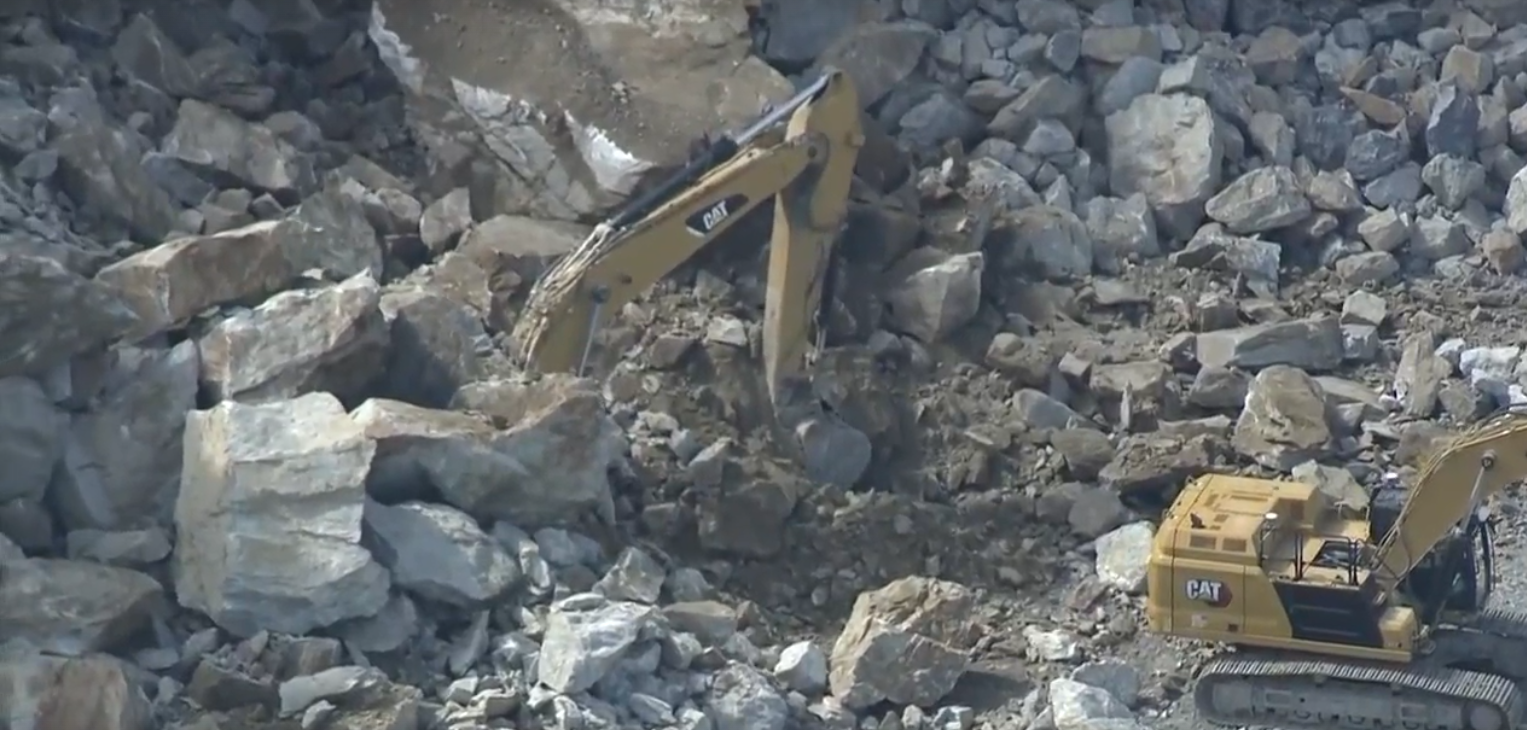 Excavator buried after rock wall collapse at quarry in Sterling