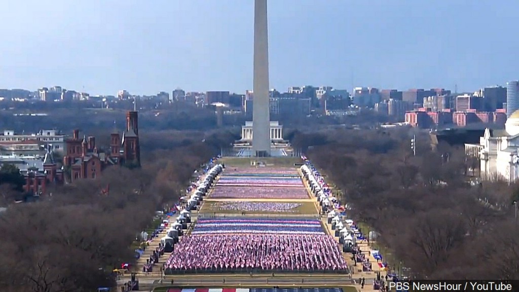 Flags stand in for what would normally be thousands of onlookers on National Mall.