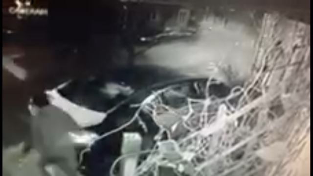 Surveillance Image Of Someone In Car Walking Off Camera