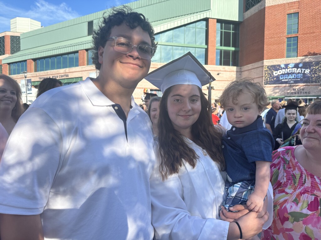 Warwick student-parent walks with son at graduation