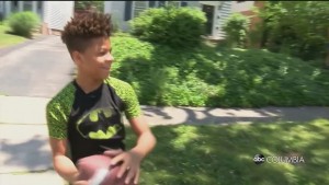 Kid And Cop Play Football