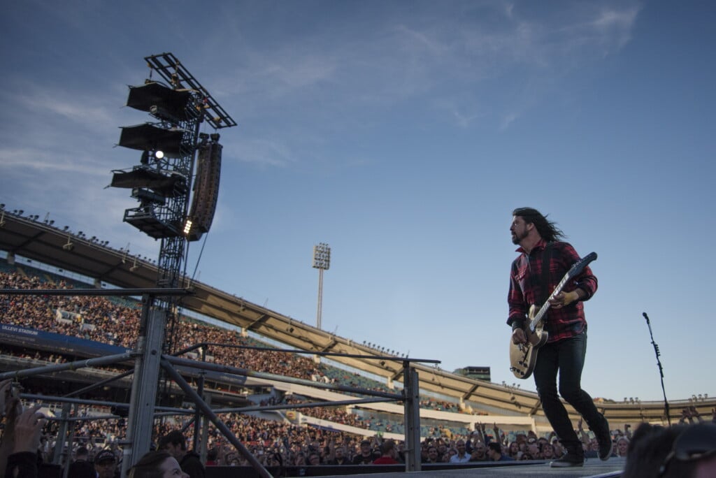 Foo Fighters Band Member Dave Grohl Is Seen On A Big Screen Talking On A Microphone After Falling From The Stage During The Band's Concert At Nya Ullevi In Gothenburg