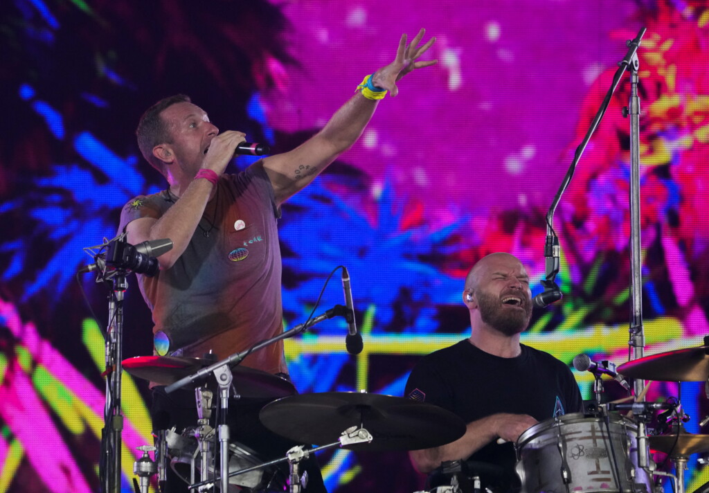 Will Champion of Coldplay performs on stage at Wembley Stadium