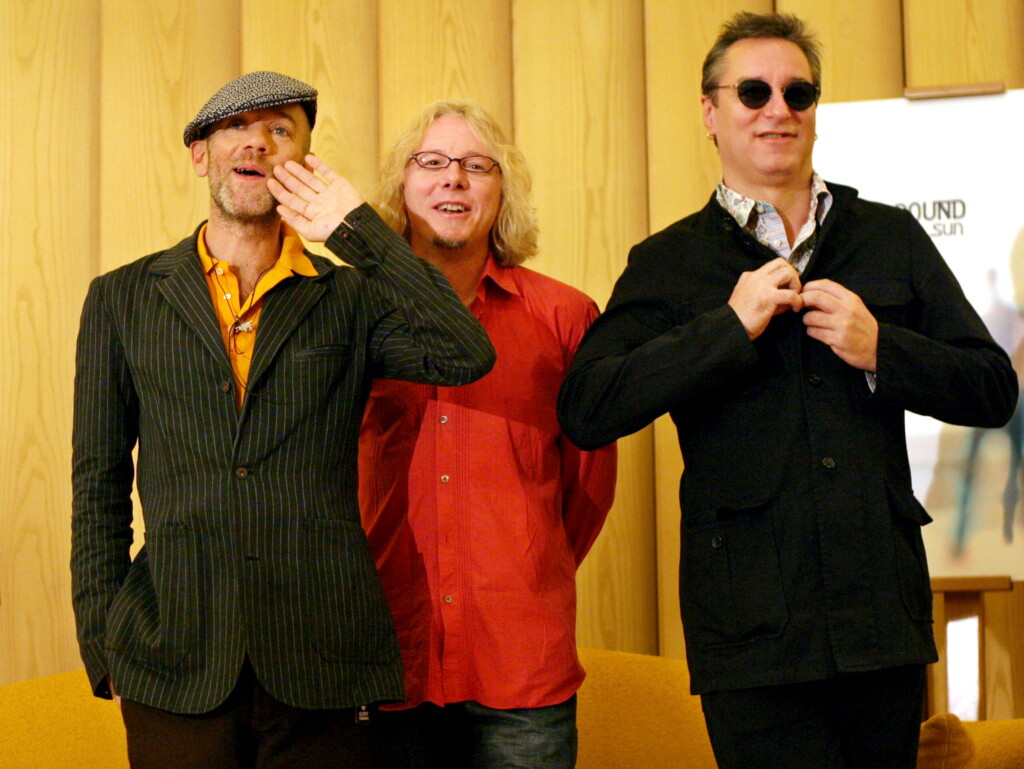 R.e.m Lead Singer Michael Stipe (l) Jokes With Band Members Mike Mills (c) And Peter Buck (r) During..
