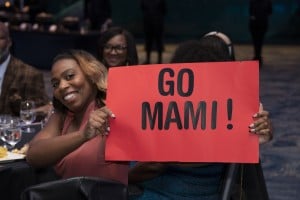 Georgia Business Magazine Woman Holding Sign That Says Go Mami