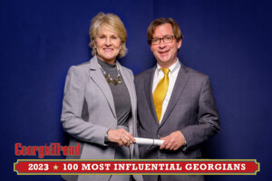 A 2023 Most Influential Georgian Standing with Ben Young Georgia Trend Publisher smiling at camera