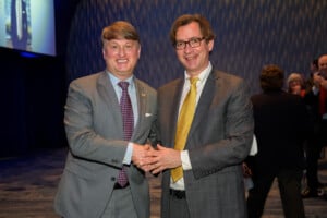 Georgia Trend publisher Ben Young, and 2023 Georgian of the Year Pat Wilson shakinig hands, both in sutes and ties at the event for 2023 Most Influential Georgians