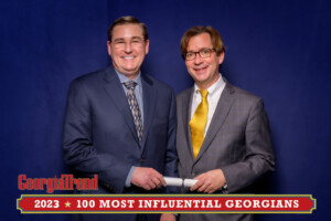 A 2023 Most Influential Georgian Standing with Ben Young Georgia Trend Publisher smiling at camera