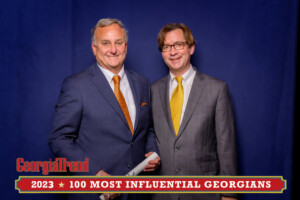 A 2023 Most Influential Georgian Standing with Ben Young Georgia Trend Publisher smiling at camera
