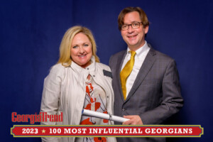 A 2023 Most Influential Georgian Standing with Ben Young Georgia Trend Publisher smiling at camera