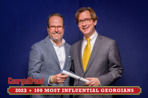 A 2023 Most Influential Georgian Standing with Ben Young Georgia Trend Publisher smiling at camera