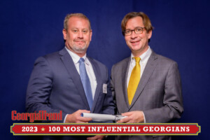 A 2023 Most Influential Georgian Standing with Ben Young Georgia Trend Publisher smiling at camera