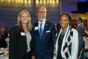 Hall of Fame Inductee Calvin Smyre standing with two women at the 2023 Most Influential Georgians ceremony honoring him