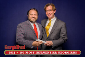 A 2023 Most Influential Georgian Standing with Ben Young Georgia Trend Publisher smiling at camera