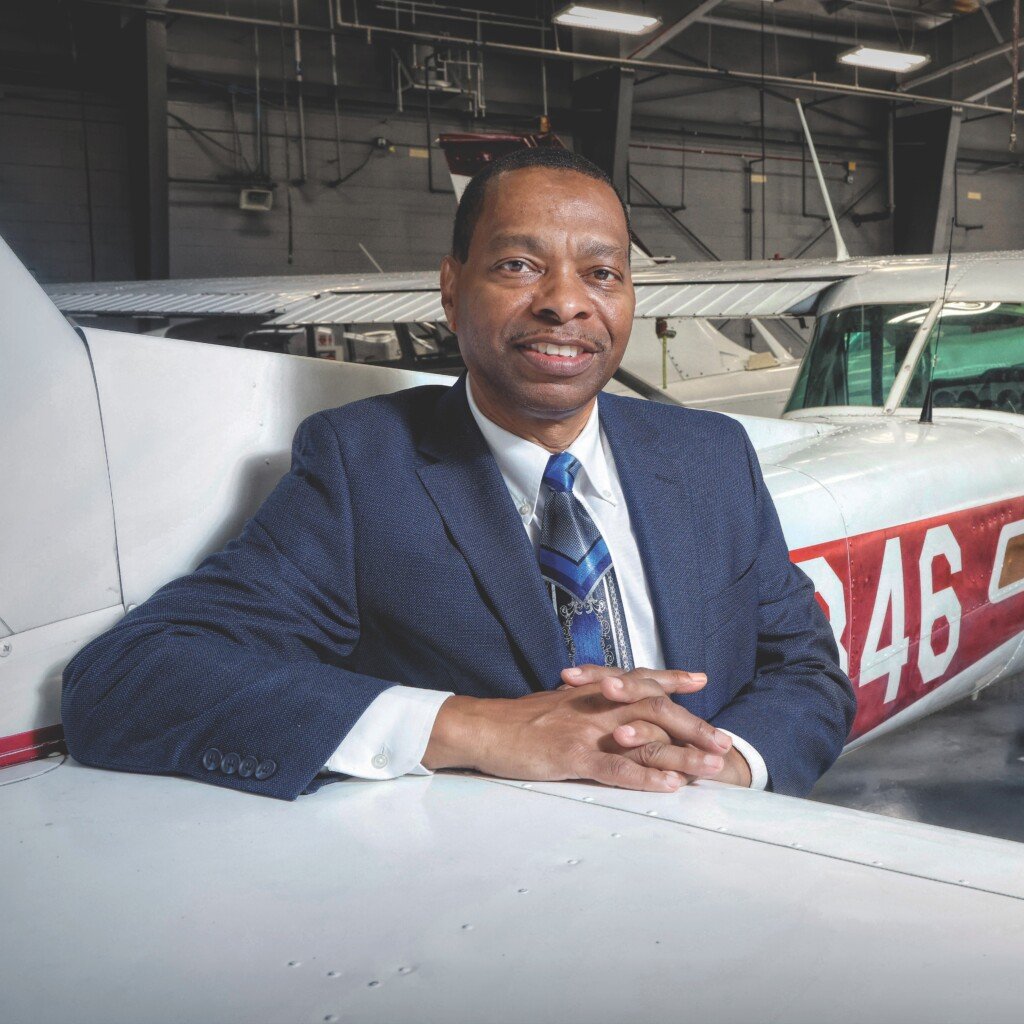 Jimmie Smith sitting near a plane