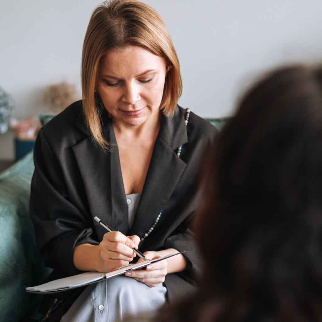 Young Woman Talking To Psychologist In The Office
