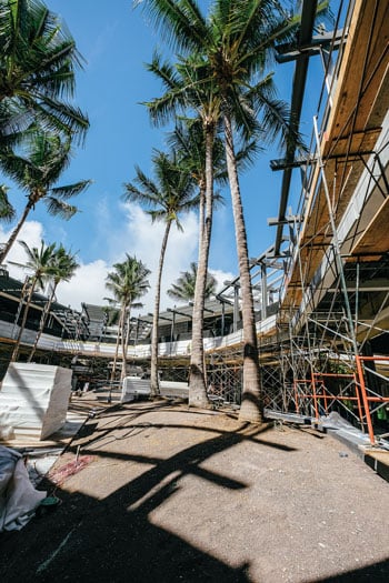 To accentuate its Hawaii setting, the new Ewa wing incorporates tropical plants, trellises and Pacific-sourced materials, like teak benches and basalt dimension stone. The precast concrete facade of the new Nordstrom store is produced locally by Grace Pacific’s GPRM Prestress subsidiary. Photo: Aaron K. Yoshino