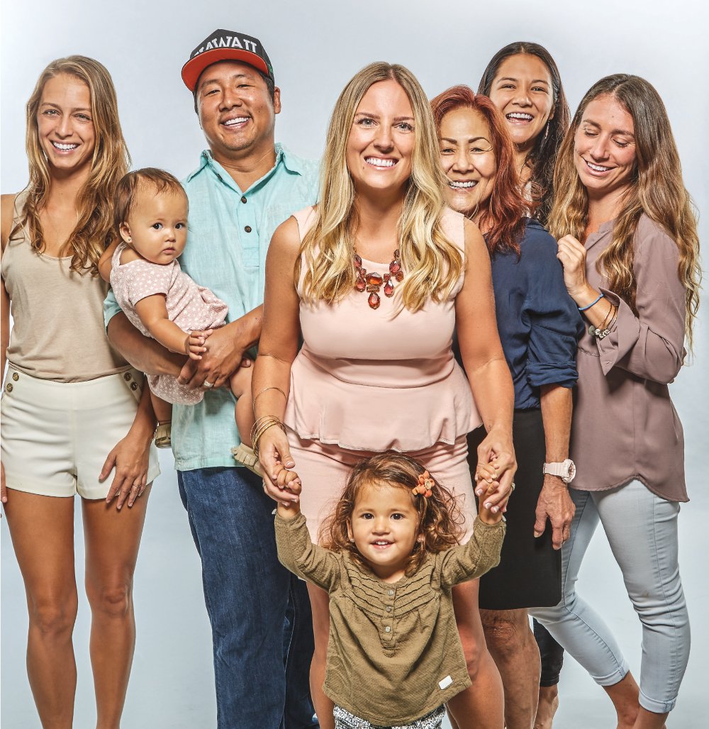 Amanda Corby Noguchi’s Village:From left: Nitasha Stiritz, event manager of Under My Umbrella; daughter Frankee (1); husband, Mark Noguchi; daughter Elee (2) with Amanda; Mark’s mother, Eleanor Noguchi; Jasmine Gamboa, who started as a babysitter for the girls and is now a part-time employee of Under My Umbrella; and Mariah Gergen, who Amanda describes as “corporate wife, event director and office administrator” for Pili Group and Under My Umbrella. Not pictured are Hideo Noguchi and Keiko Gerstle.