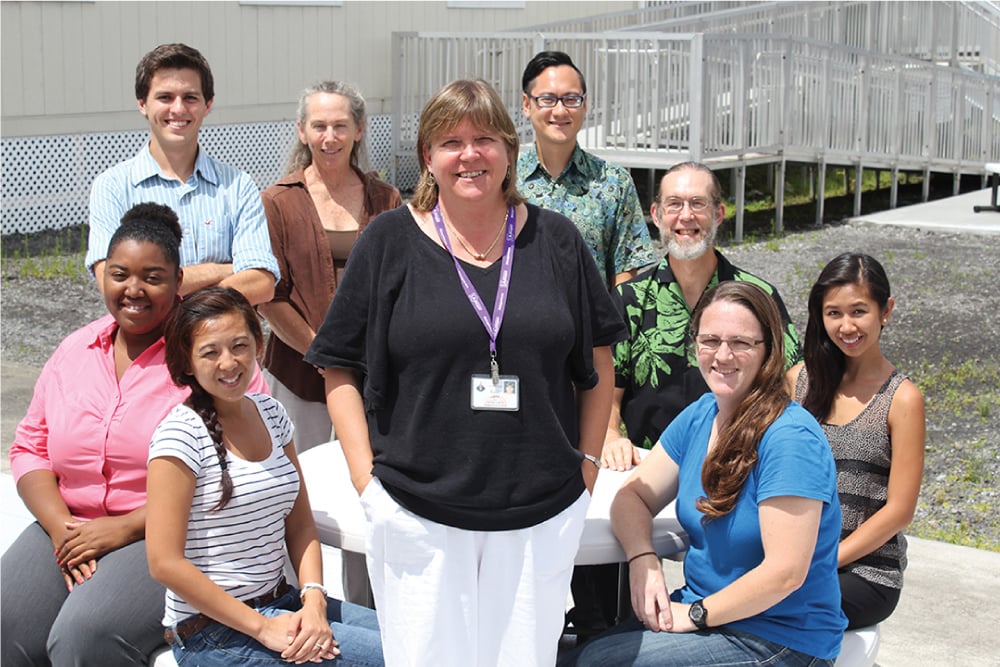 Sue Jarvi (center) who helps lead the Hawaii island Rat Lungworm Working Group, is joined by, clockwise from Jarvi's right: Ann Txakeeyang, LaTasha Riddick, Michael Severino, Kay Howe, Akio Yanigisawa, Steven Jaquier, Jill Villarosa and Peggy Farias. Photo courtesy Daniel K Inouye College of Pharmacy. 