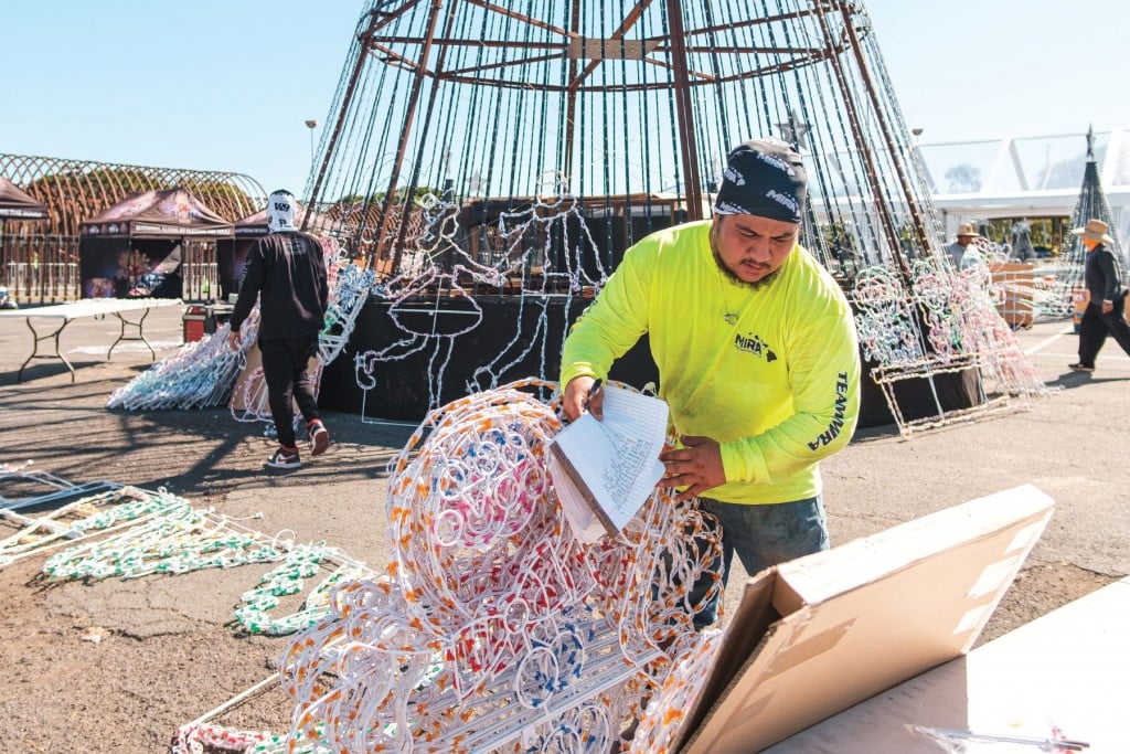 Mira Image Construction employee Sulu Cook pulls out a string of lights, part of an estimated 3 million lights used to create the second annual Show Aloha Winter Wonderland.