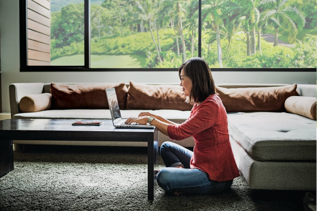 Woman Using Laptop At Home