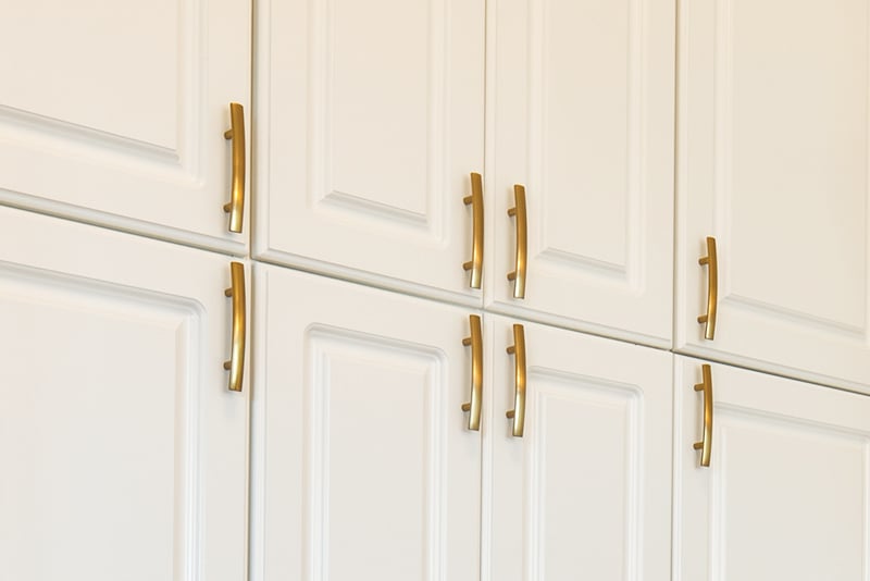 timeless brass hardware on white cabinetry