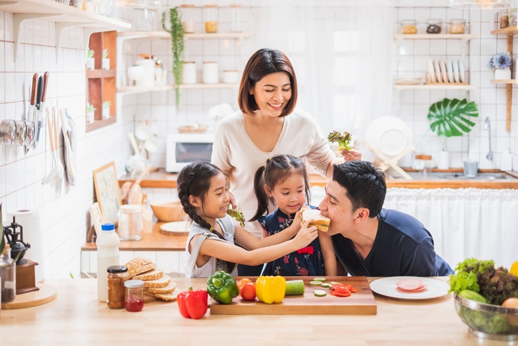 Asian family is cooking in the kitchen together