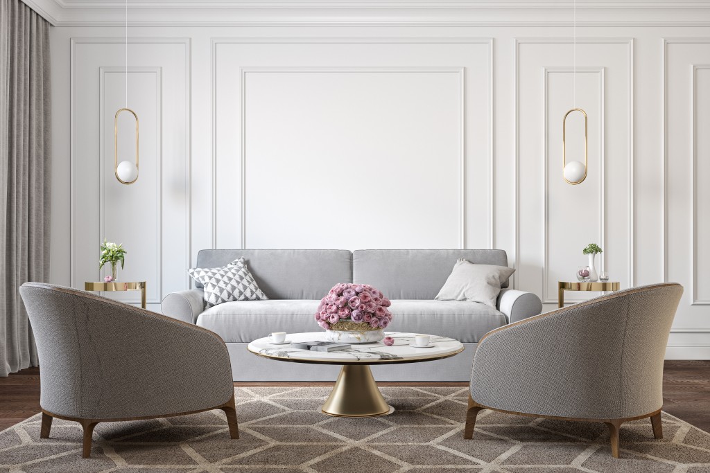 Classic White Interior With Gray Armchairs, Sofa, Marble Coffee Table, Lamps, Carpet, Flowers And Wall Moldings. 3d Render Illustration Mockup.