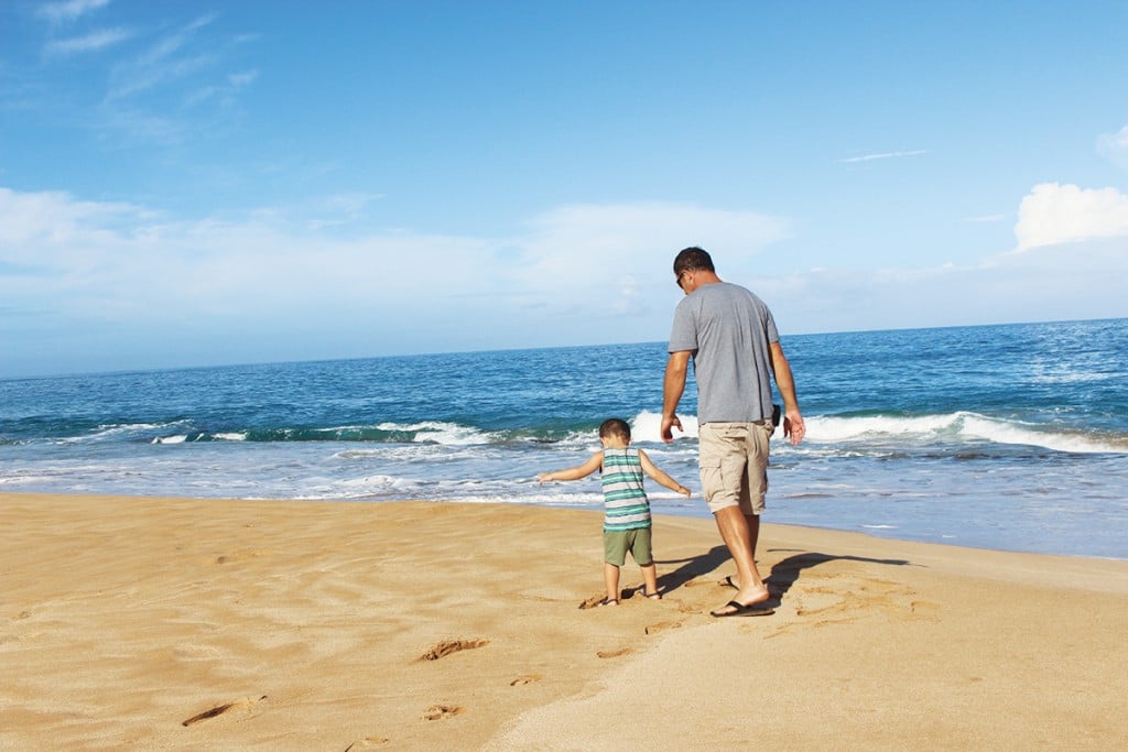 family on molokai walking on the beach