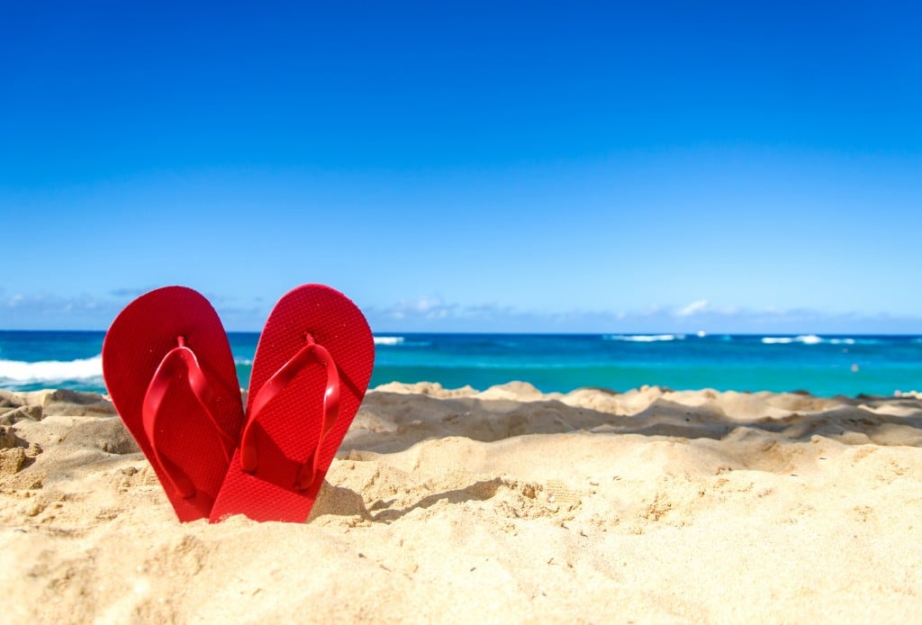 Red Flip Flops On The Sandy Beach