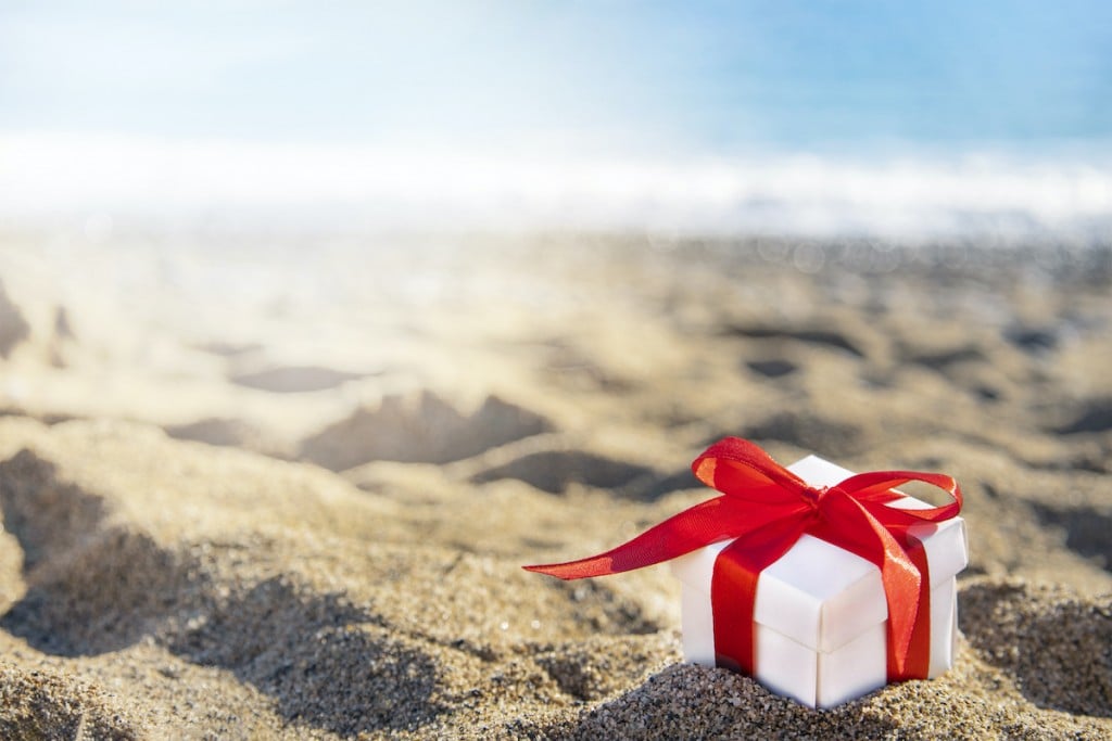 Gift Box With A Red Ribbon On The Beach