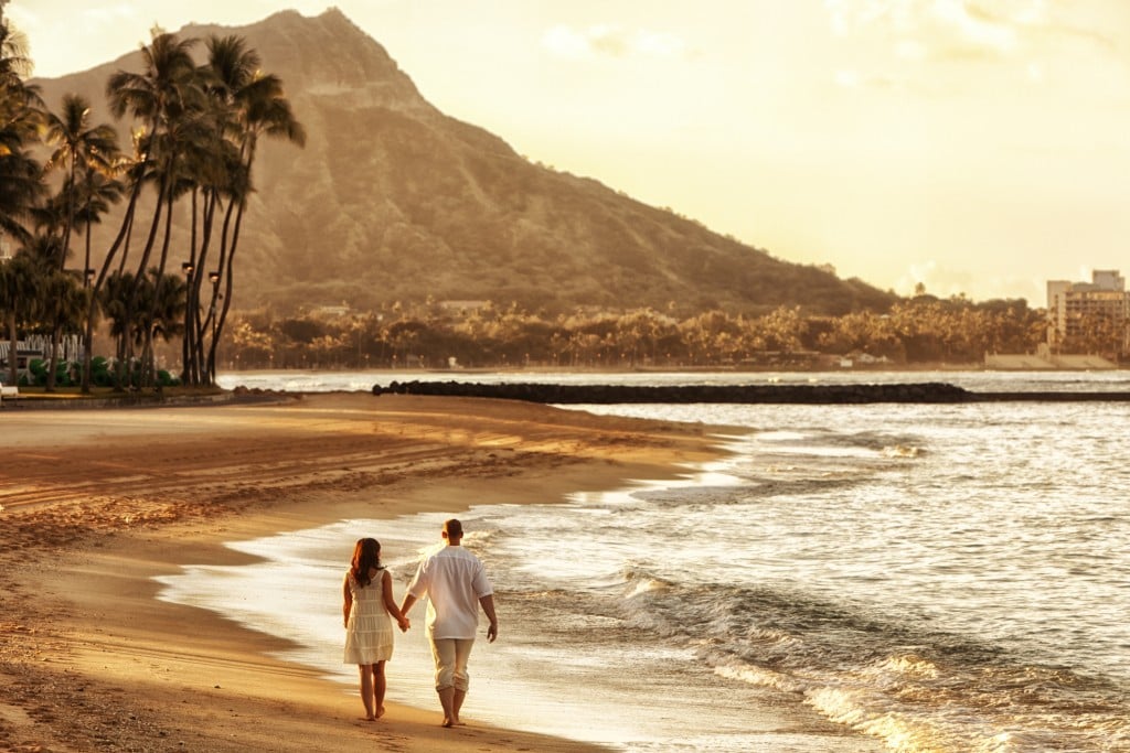 Happy Couple Walking On Waikiki Beach At Sunrise