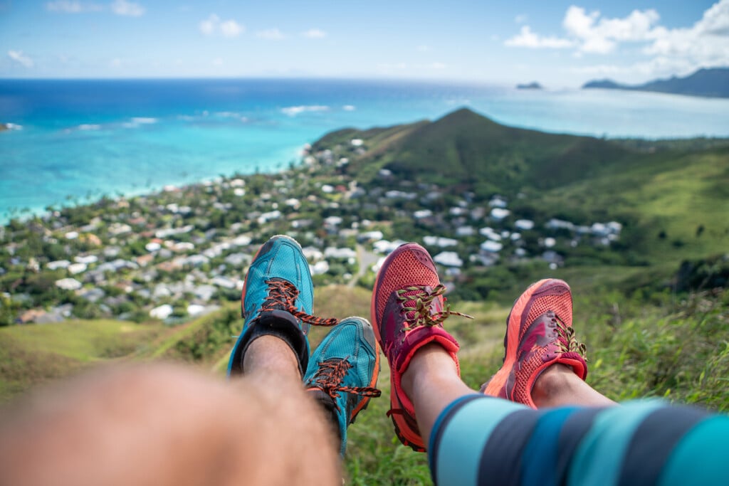 Personal Perspective Of Hikers Resting On Mountain Top, Sea View