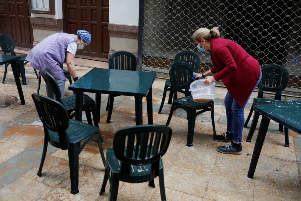 Waitresses Clean Bar Terrace As A Storm Blew Sand From The Sahara Desert Over Andalusia, In Ronda