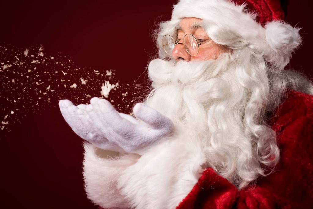 Santa Claus blowing some snowflakes (Source: Storyblocks)