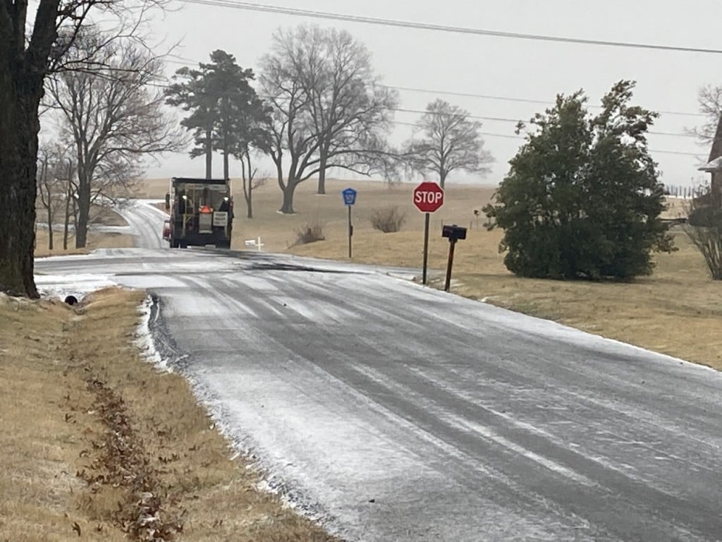 A county highway truck spreads cinders on slick roads just west of Jackson, Mo. the afternoon of Wednesday, Feb. 2
