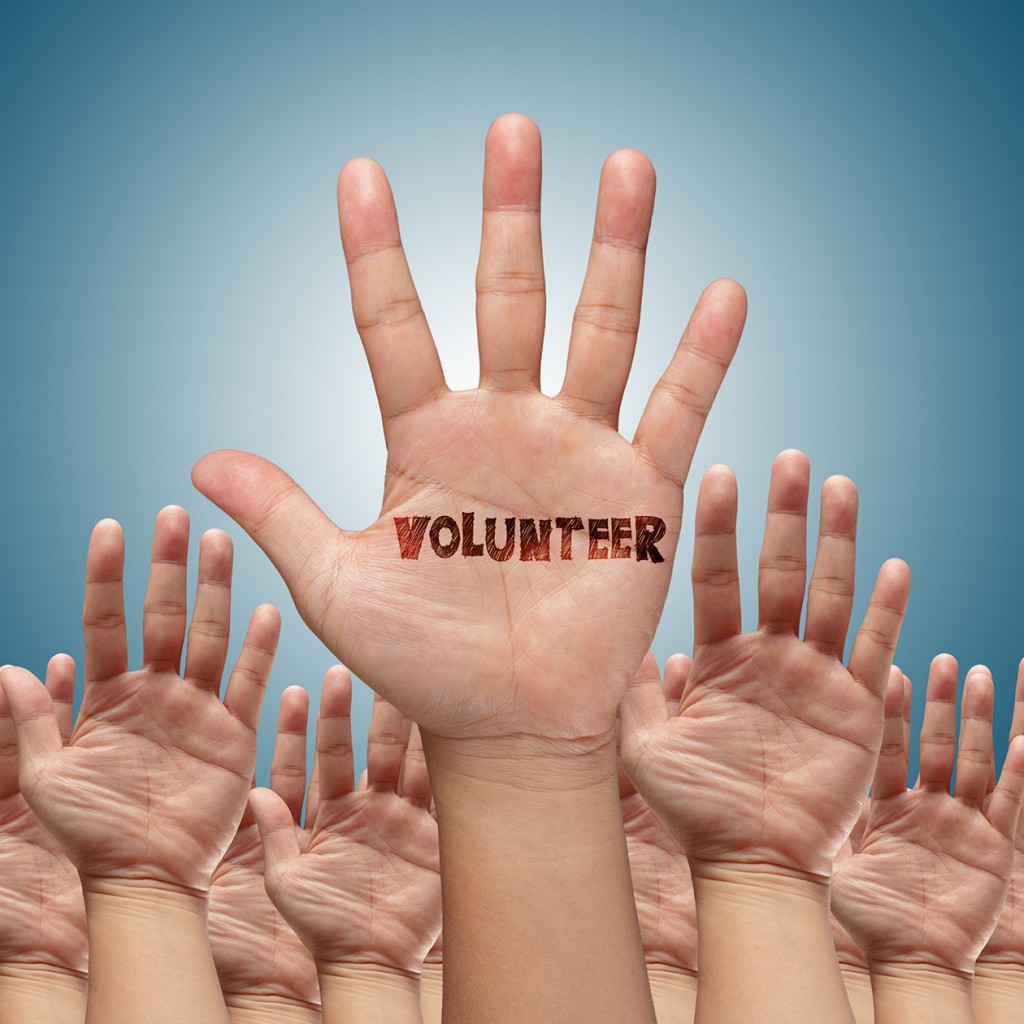 Volunteer Group Raising Hands (Source: Storyblocks)