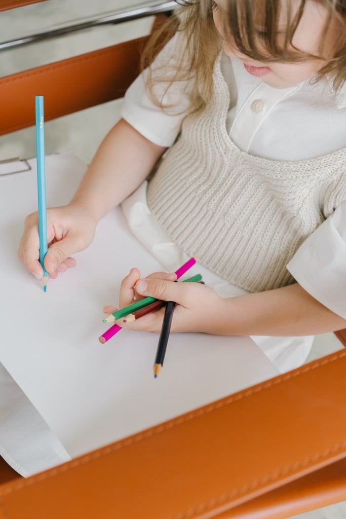 child with colored pencils (Source: Pexels/Mikhail Nilov)