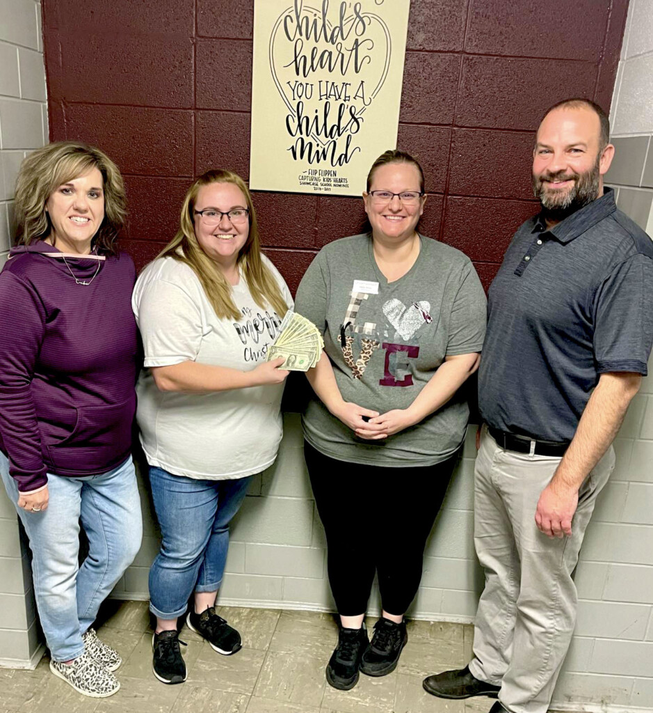 Candace Warren (left) and Corey Jameson of Junior High accept a donation from Ross Fuel Center manager Tiffany Voyles (second from left) and Joyce West, assistant manager, on Friday, Dec. 2. (Source: Poplar Bluff R-I School District)