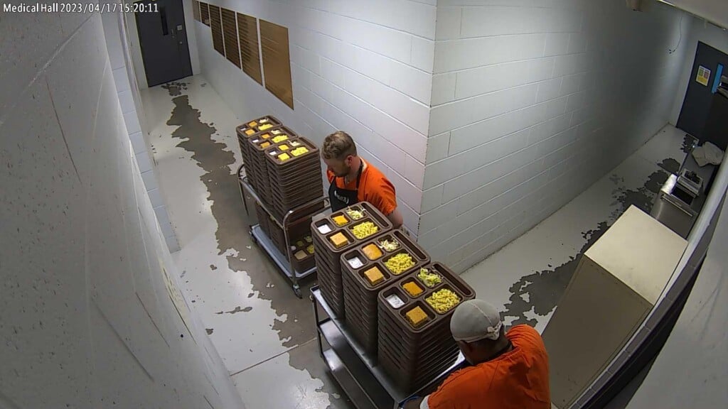The trustees pray before they serve the trays. They do this before every meal, according to the sheriff's office. (Source: Mississippi County Sheriff's Office/Facebook)