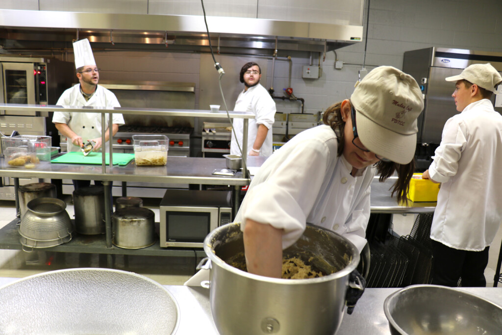 TCC culinary arts students, under the instruction of Chef Brandon Moon (left), prepare on Tuesday, Sept. 19, for this week’s re-opening of the Mules Café (Source: Poplar Bluff School District)