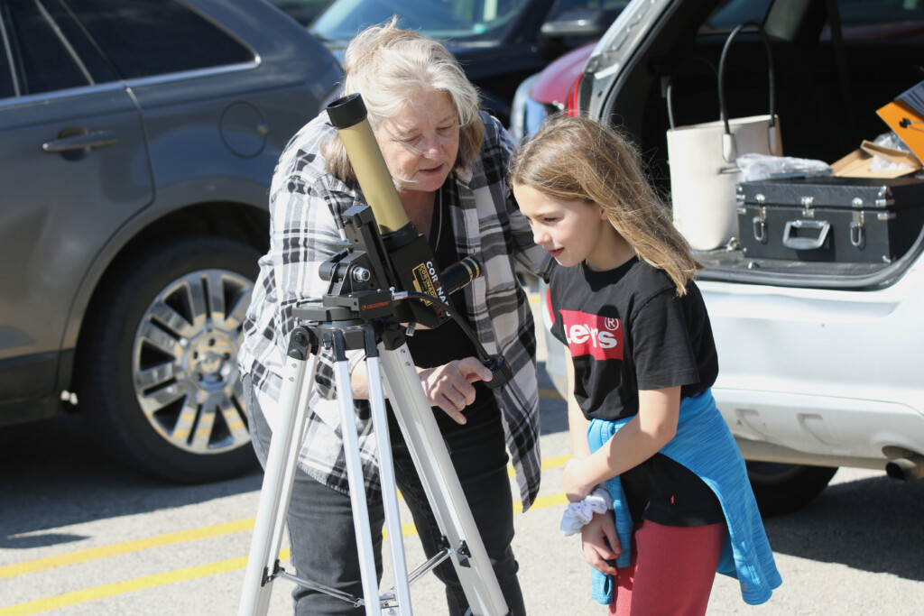 Connie Roberson of the Poplar Bluff Municipal Library, whose husband Kevin is an amateur astrophotographer, assists Carol Leezer, grade three, in operating the solar telescope on Friday, Oct. 20, at O’Neal Elementary (Source: Poplar Bluff School District)