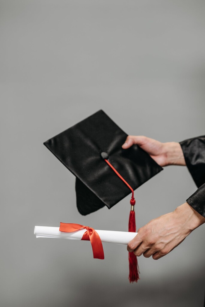 hands holding graduation cap and diploma (Source: Pexels/Pavel Danilyuk)