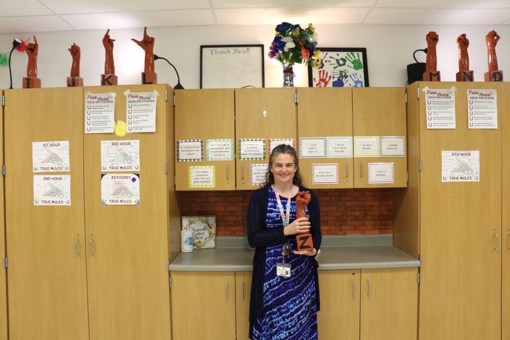 American sign language teacher Audrey Harris holds up a life-sized sculpture hand-crafted by a St. Louis artist for her classroom. (Source: Poplar Bluff R I School District)